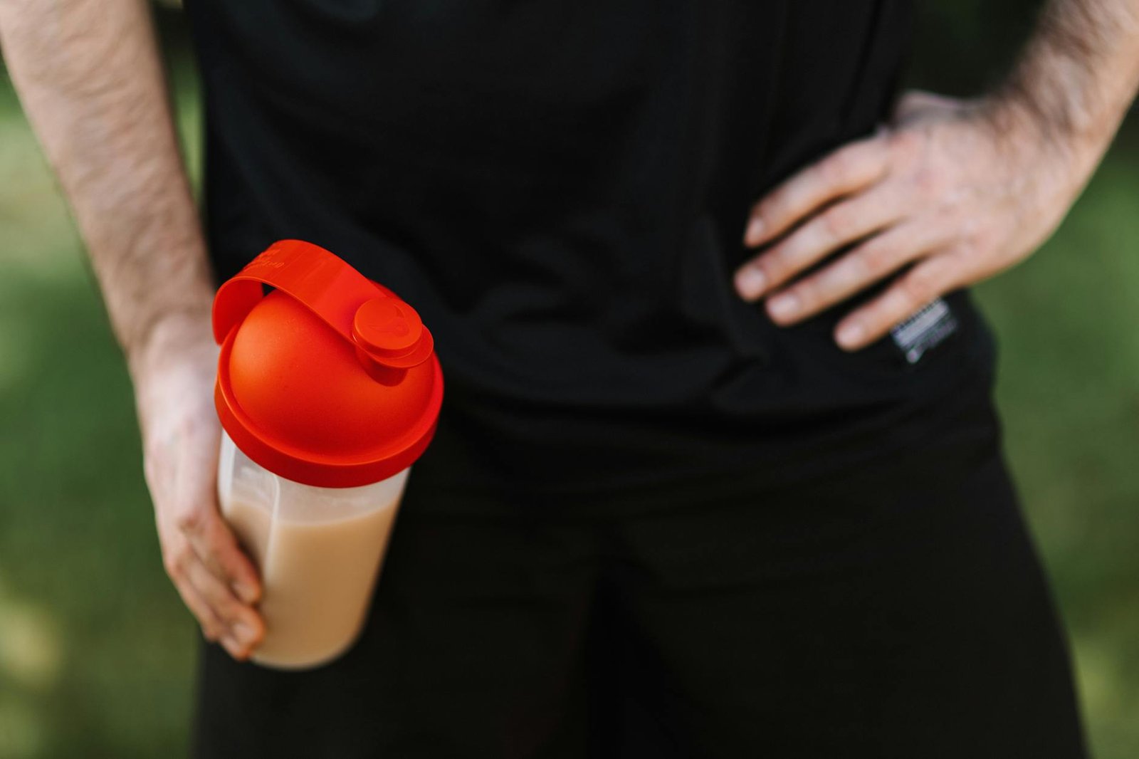 https://www.pexels.com/photo/man-holding-a-tumbler-with-hand-on-waist-4378487/